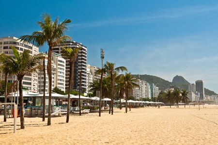 Empty Copacabana Beach view with palm trees, hotel and apartment buildings, and Sugarloaf Mountain in the horizon. Rio de Janeiro, Brazilの写真素材