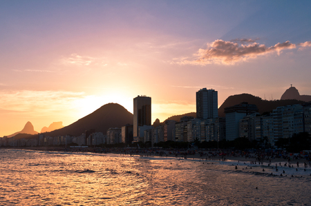 Copacabana Beach View with Hotel Buildings and Mountains by Warm Sunset in Rio de Janeiro, Brazilの写真素材