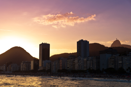 Copacabana Beach View with Hotel Buildings and Mountains by Warm Sunset in Rio de Janeiro, Brazil