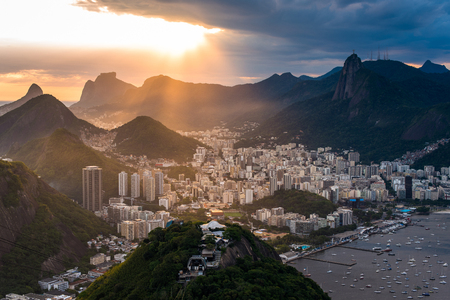 Sun is shining through the clouds on the Rio de Janeiro city, View from the Sugarloaf Mountain