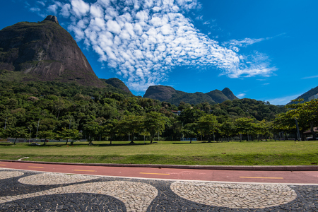 Famous Copacabana Style Mosaic Sidewalk and Beautiful Mountain Landscape With Pedra da Gavea in Rio de Janeiro, Brazilの写真素材