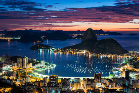 Rio de Janeiro city just before sunrise with city lights on, and the Sugarloaf Mountain in the horizonの写真素材