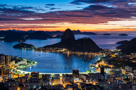 Rio de Janeiro city just before sunrise with city lights on, and the Sugarloaf Mountain in the horizonの写真素材