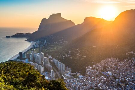 View of Sao Conrado During Beautiful Colorful Sunset Behind Mountains of Rio de Janeiro, Brazilの写真素材