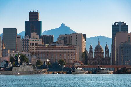 View of Rio de Janeiro Downtown With Candelaria Church, Marine Ships in Water, and Mountains in Backgroundの写真素材