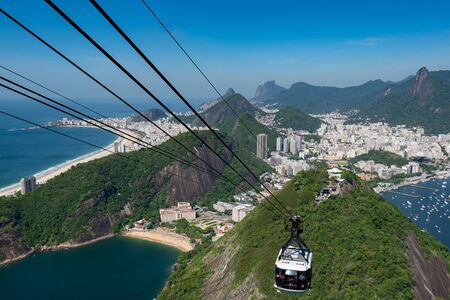 Cable Car Approaching the Sugarloaf Mountain With Beautiful View or Rio de Janeiro City Behindの写真素材