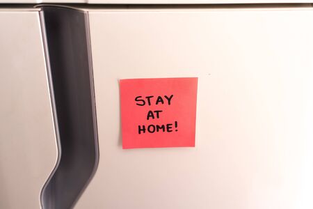 Sticky Note on the Refrigerator Saying Stay at Home!の写真素材
