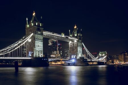 Tower Bridge Illuminated at Night in London, UKの写真素材