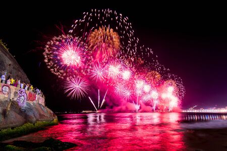 Spectacular fireworks display above water in Copacabana beach, celebrating New Year