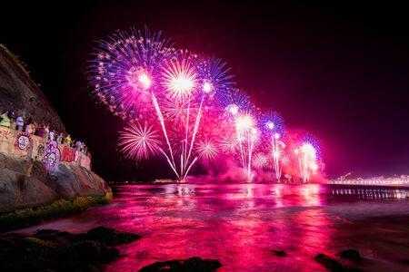 Spectacular fireworks display above water in Copacabana beach, celebrating New Yearの写真素材