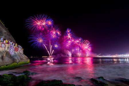 Spectacular fireworks display above water in Copacabana beach, celebrating New Yearの写真素材