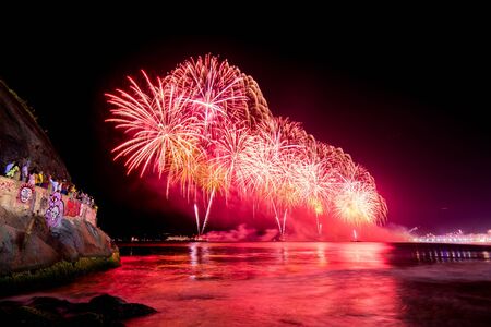 Spectacular fireworks display above water in Copacabana beach, celebrating New Yearの写真素材