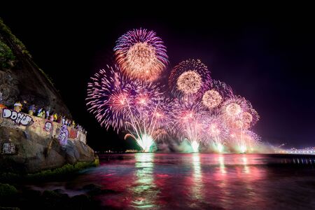 Spectacular fireworks display above water in Copacabana beach, celebrating New Yearの写真素材