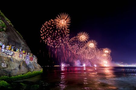 Spectacular fireworks display above water in Copacabana beach, celebrating New Yearの写真素材