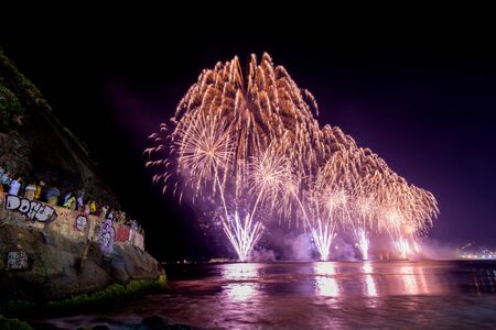 Spectacular fireworks display above water in Copacabana beach, celebrating New Yearの写真素材