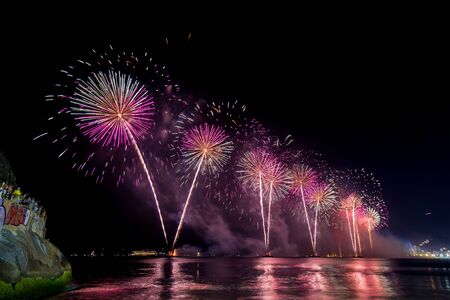 Spectacular fireworks display above water in Copacabana beach, celebrating New Yearの写真素材