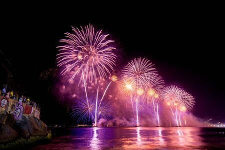 Spectacular fireworks display above water in Copacabana beach, celebrating New Yearの写真素材