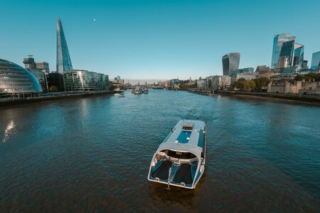 Commuter Bus Boat in Thames River Towards the City of Londonの写真素材