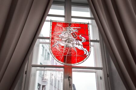 Coat of Arms of Lithuania on the Window With Curtainsの写真素材