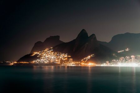 Night View of Mountains, Vidigal Slum and Leblon Beach With Lights, in Rio de Janeiro, Brazilの写真素材