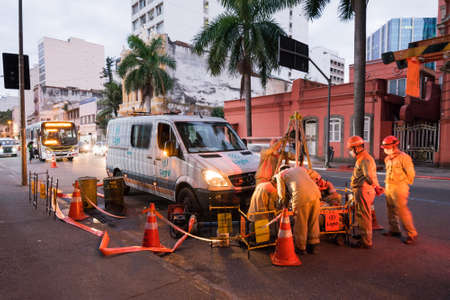 Rio de Janeiro, Brazil - July 2, 2020: Group of electrician workers are making repairs in the city street.のeditorial素材