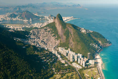 Aerial View of Two Brothers Mountain With Biggest in Brazil Favela Rocinha and Apartment Buildings at Bottom in Front of the Beach in Rio de Janeiroの写真素材