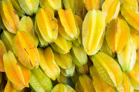 Pile of Fresh Star Apple or Carambola Fruits at the Marketの写真素材