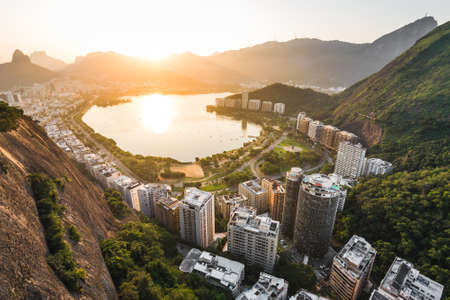 Beautiful View of Rodrigo de Freitas Lagoon by Sunset Surrounded by Apartment Buildings and Mountains in Rio de Janeiro, Brazil.の写真素材