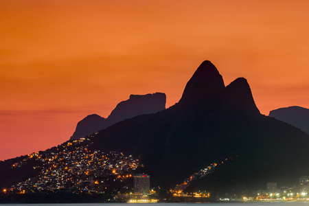 Two Brothers Mountain and Pedra da Gavea, Vidigal Favela Lights at Sunset in Rio de Janeiro, Brazil.の写真素材
