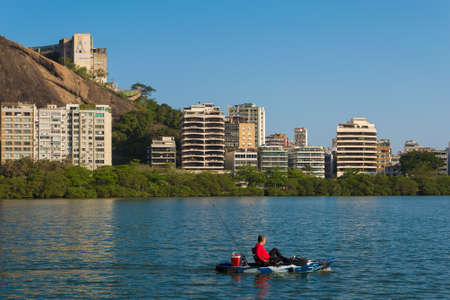 Fisherman on Boat in the Lagoon in Rio de Janeiro, Brazil.のeditorial素材