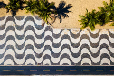 Top View of Copacabana Mosaic Sidewalk and Palm Trees at the Beach in Rio de Janeiro, Brazil