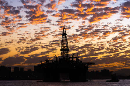 Silhouette of Oil Drilling Rig in Guanabara Bay in Rio de Janeiro, Brazil With Dramatic Sunset Skyの写真素材