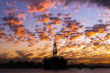 Silhouette of Oil Drilling Rig in Guanabara Bay in Rio de Janeiro, Brazil With Dramatic Sunset Skyの写真素材
