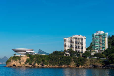 Modern Museum on the Rock and Apartment Buildings in Niteroiの写真素材