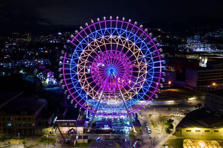Rio de Janeiro, Brazil - August 3, 2022: Yup Star (Rio Star) ferris wheel at night is illuminated with colorful RGB led lights.のeditorial素材