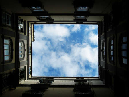 perfect sky through typical buildingsの写真素材