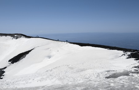 People on volcano mount Etna crater in Sicily, Italyの写真素材