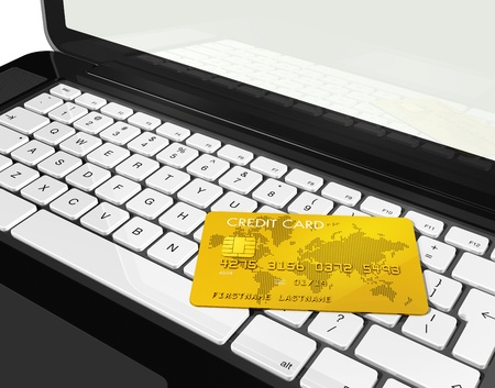 3D render of a gold credit card on a laptopの写真素材