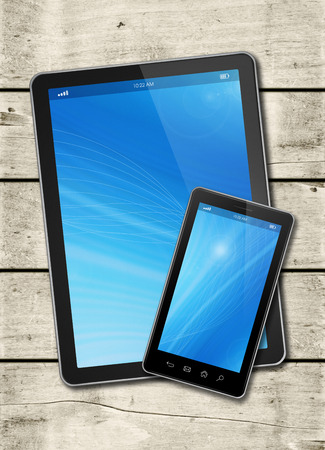 Smartphone and digital tablet PC on a white wood table - vertical office mockupの写真素材
