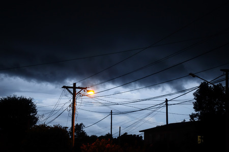 Street light at night with a stormy sky background. Dark mystery sceneの写真素材