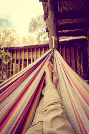 Man relaxing in a colored hammock. subjective viewの写真素材