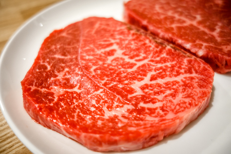 Raw Kobe wagyu beef steaks in a plateの写真素材