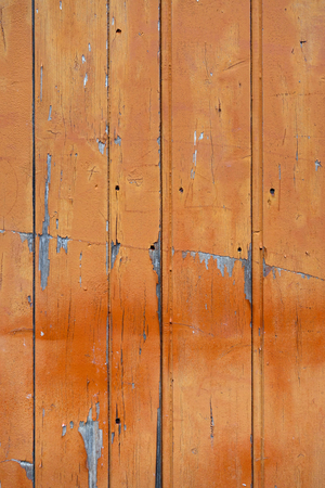 Old wood board painted orange, background textureの写真素材