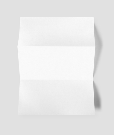 Blank folded White A4 paper sheet mockup template isolated on grey backgroundの写真素材