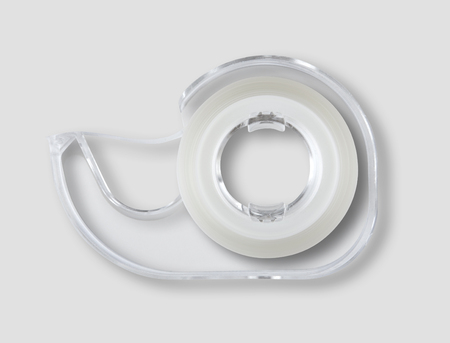 Transparent scotch tape dispenser isolated on grey backgroundの写真素材