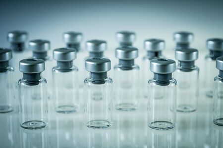Group of vaccine glass bottles on grey backgroundの写真素材