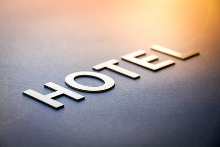 Word hotel written with white solid letters on a boardの写真素材