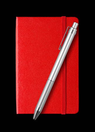 Red closed notebook and pen mockup isolated on blackの写真素材