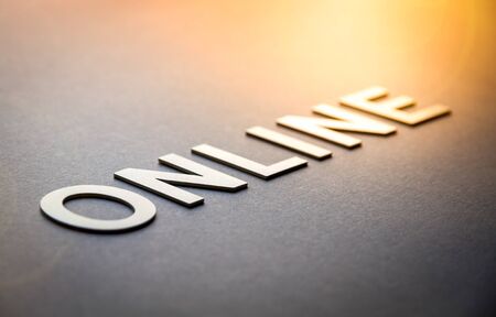 Word online written with white solid letters on a boardの写真素材