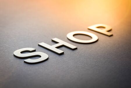Word shop written with white solid letters on a boardの写真素材